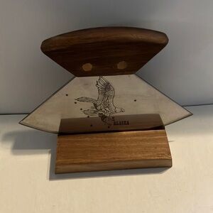 Alaskan Ulu knife with‎ a walnut wood handle and a stand.